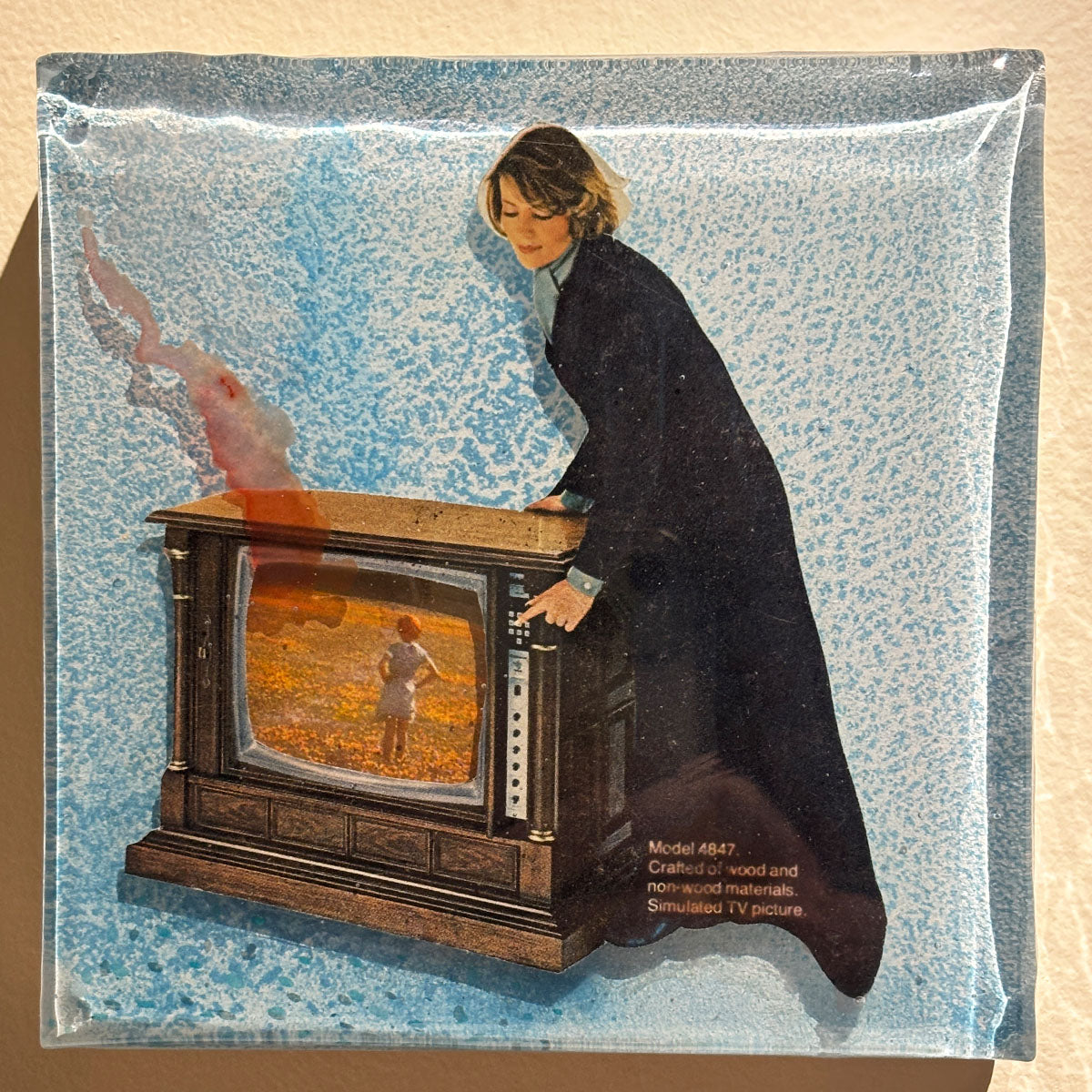 Collage of a person interacting with an old-fashioned television set on a textured beige background