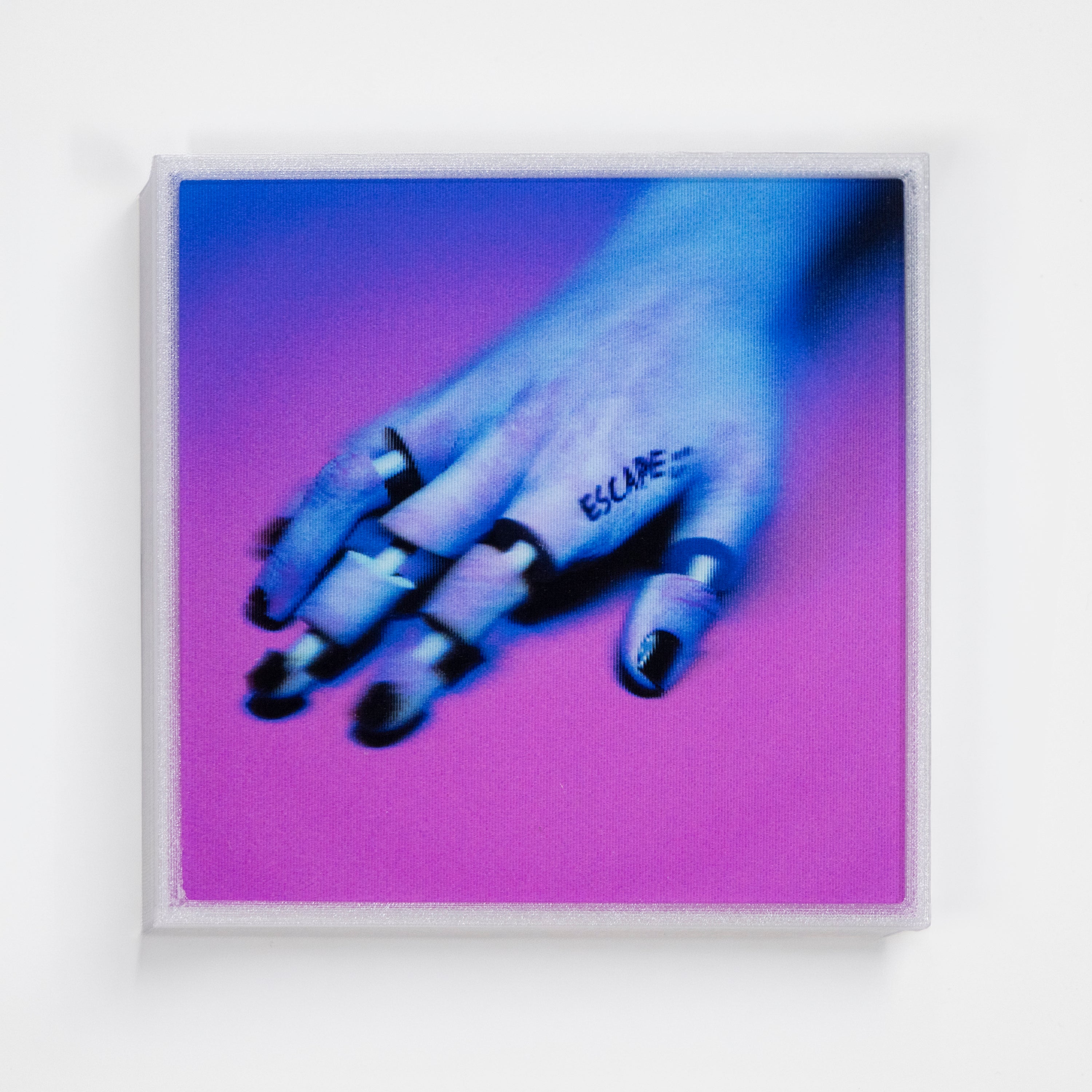 Framed artwork of a hand with 'ESCAPE' tattoo on a purple background