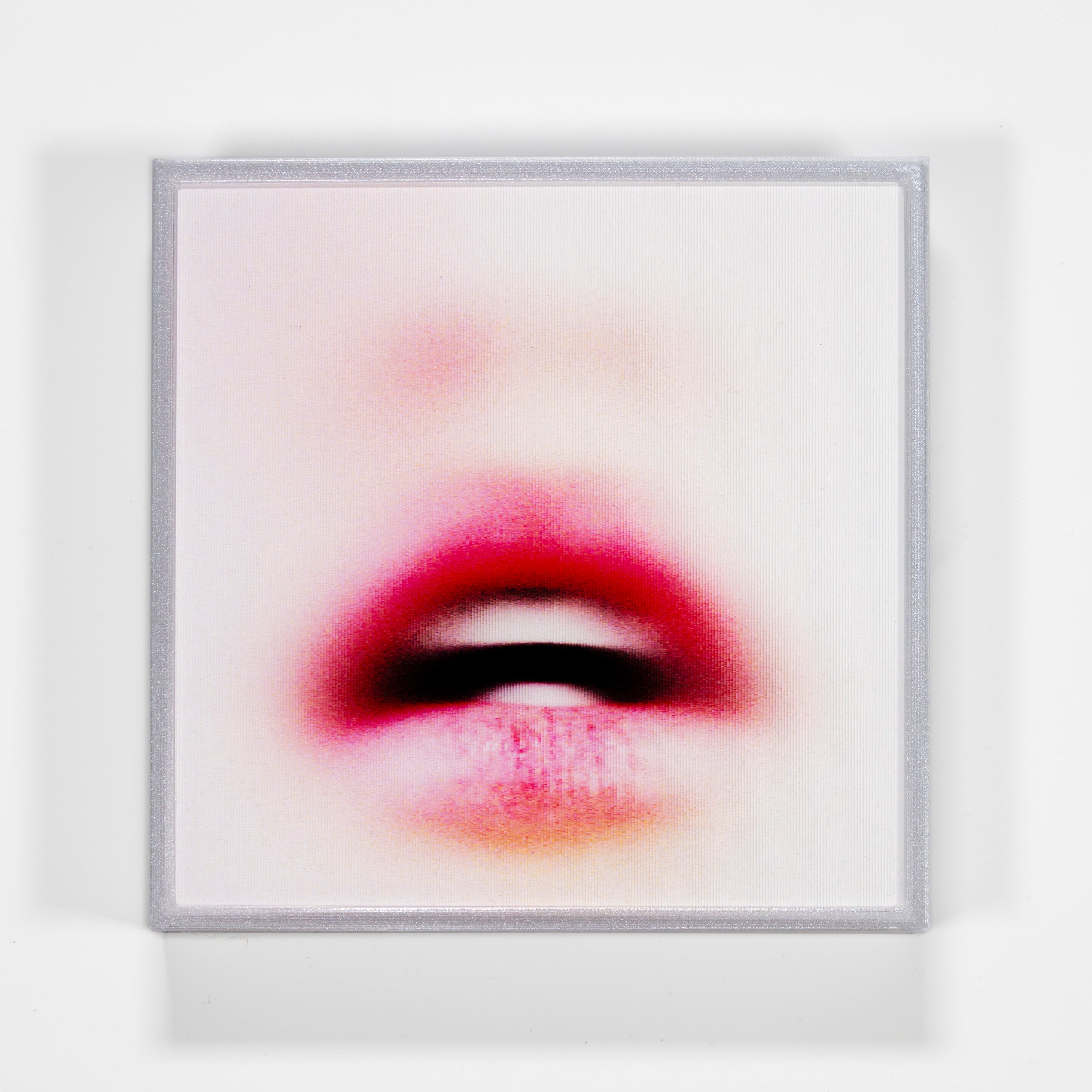 Framed artwork of a stylized mouth with red and pink tones on a white background