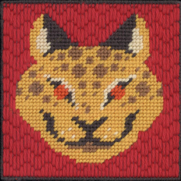 Embroidered patch of a lynx face on a red background