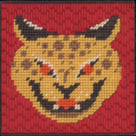 Embroidered design of a lynx face on a red background