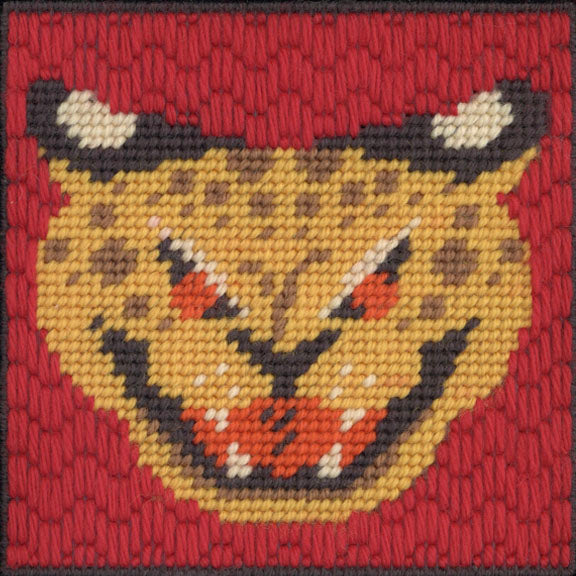 Embroidered patch of a leopards face on a red background