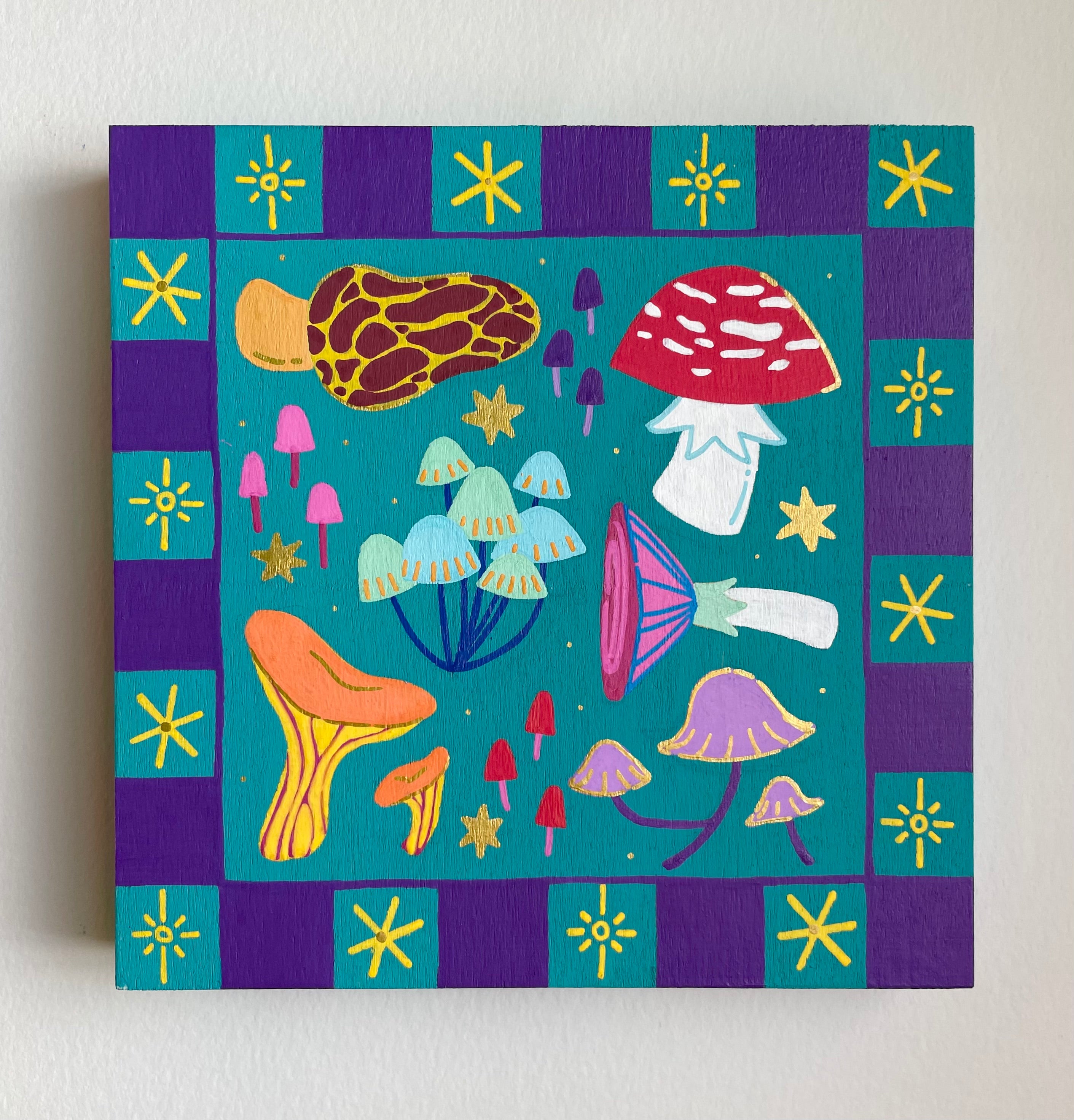 Canvas print with colorful mushroom illustrations on a blue and purple checkered background