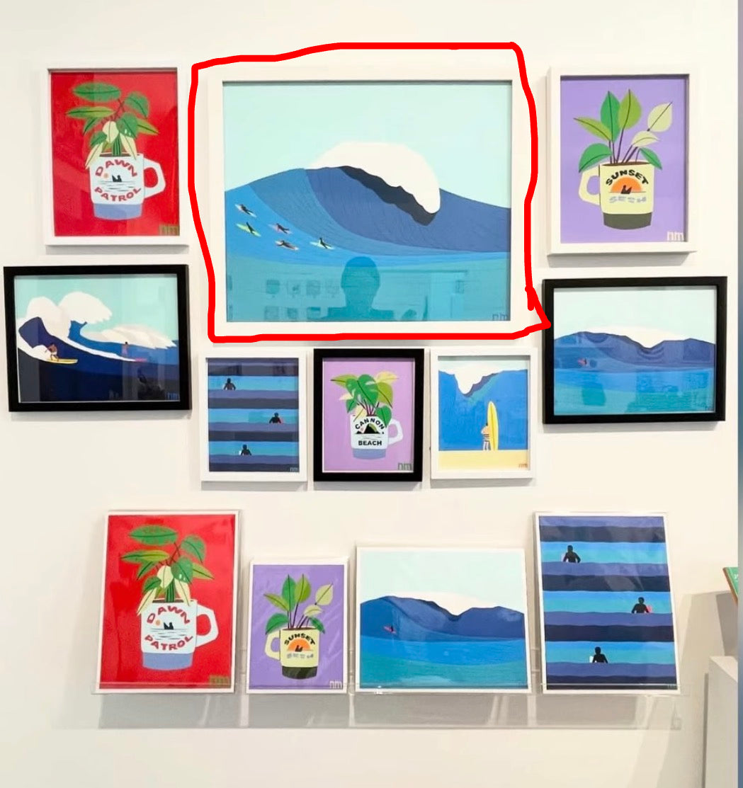 Collection of framed artworks on a wall, featuring various designs.