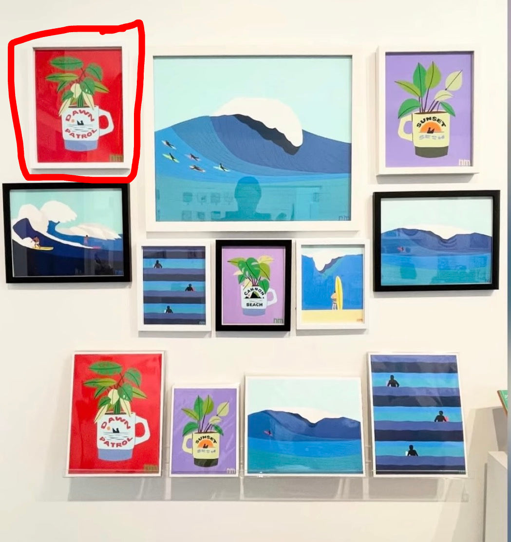 Collection of framed artworks on a wall, featuring various designs.