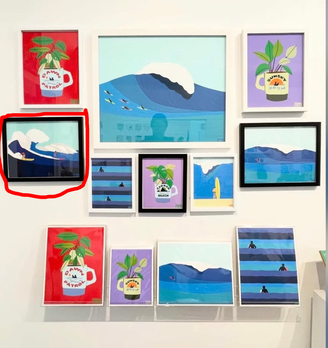 Collection of framed artworks on a wall, featuring various designs.