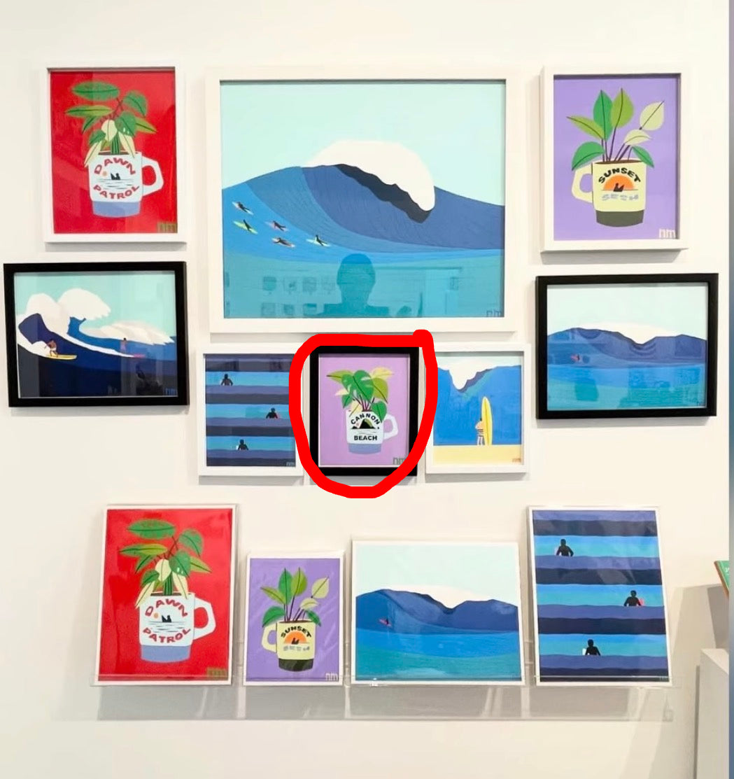 Collection of framed artworks on a wall, featuring various designs.