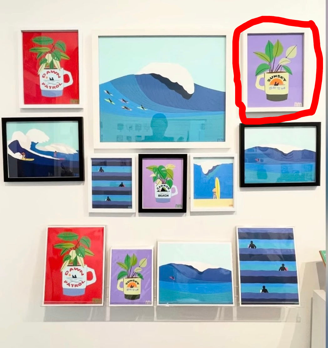 Collection of framed artworks on a wall, featuring various designs.