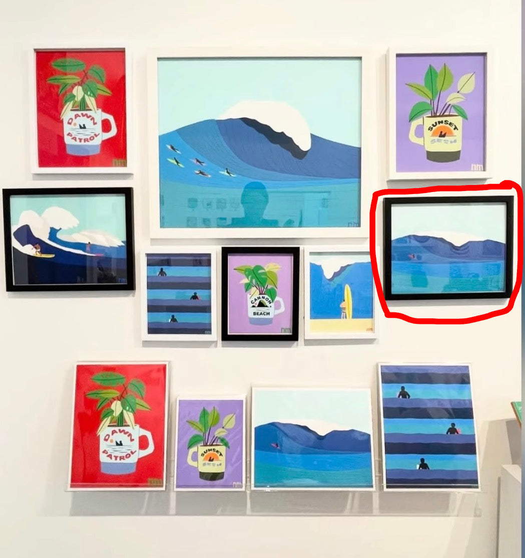 Collection of framed artworks on a wall, featuring various designs.