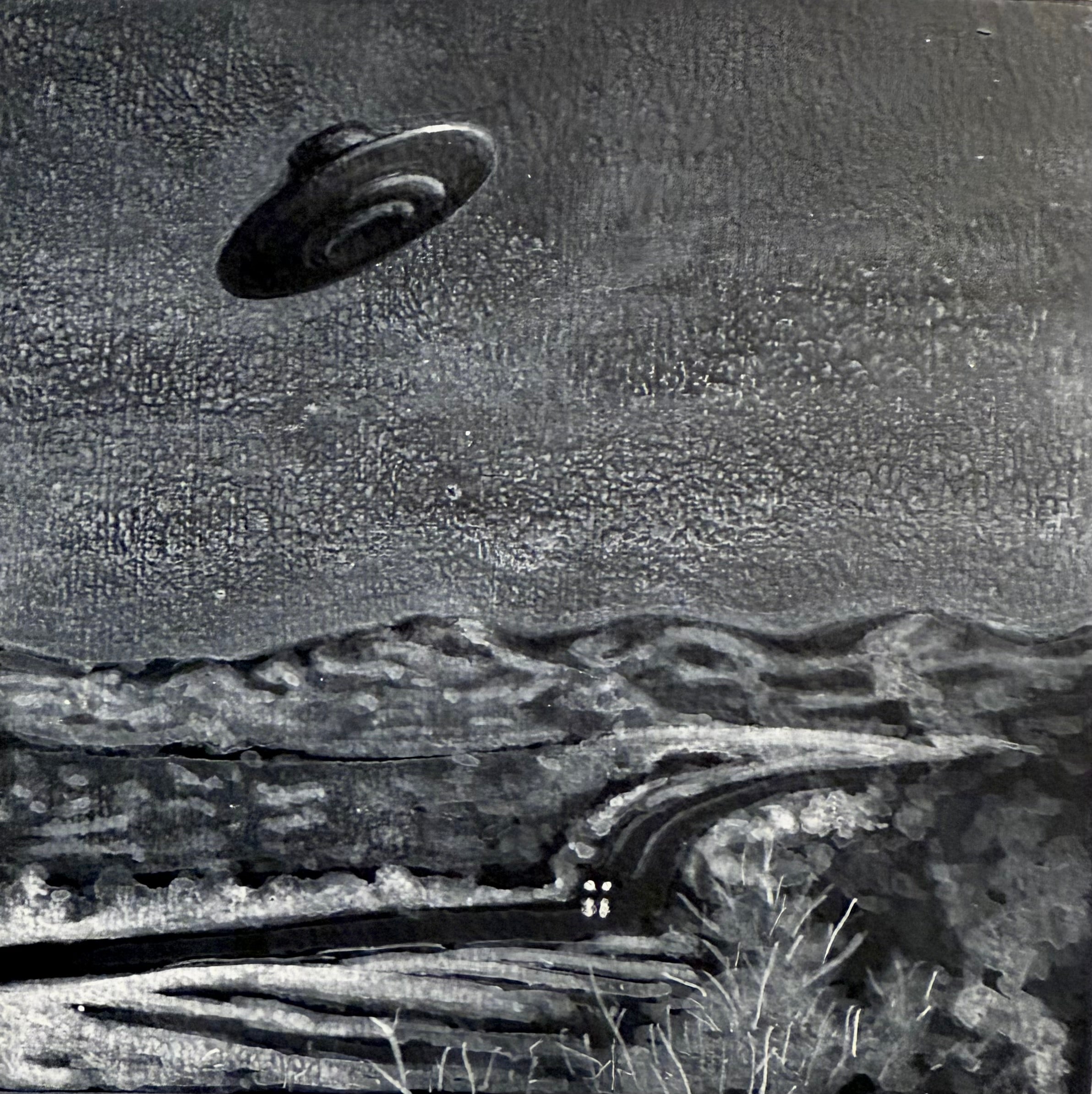 UFO flying over a desert landscape with a wooden fence and cacti.