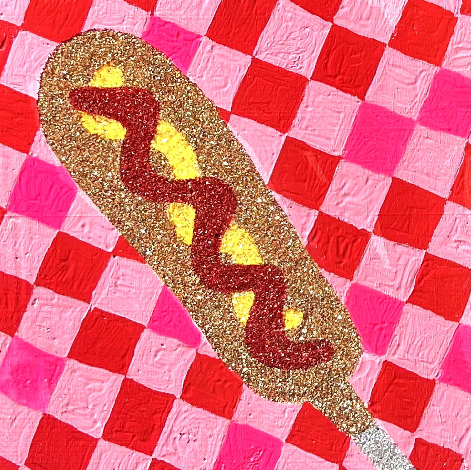Hot dog with mustard on a red and pink checkered background