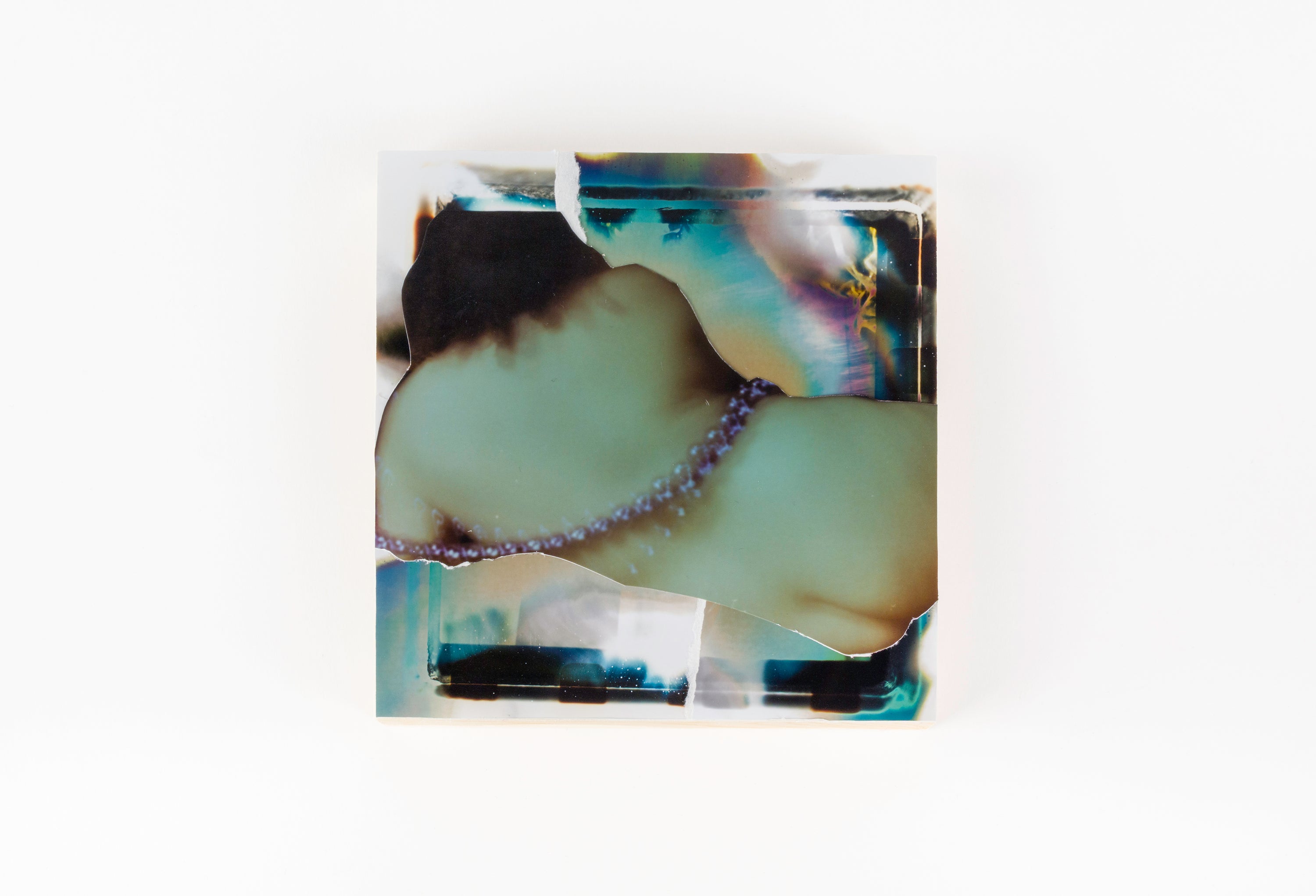 Decorative glass piece with marbled design on a white background