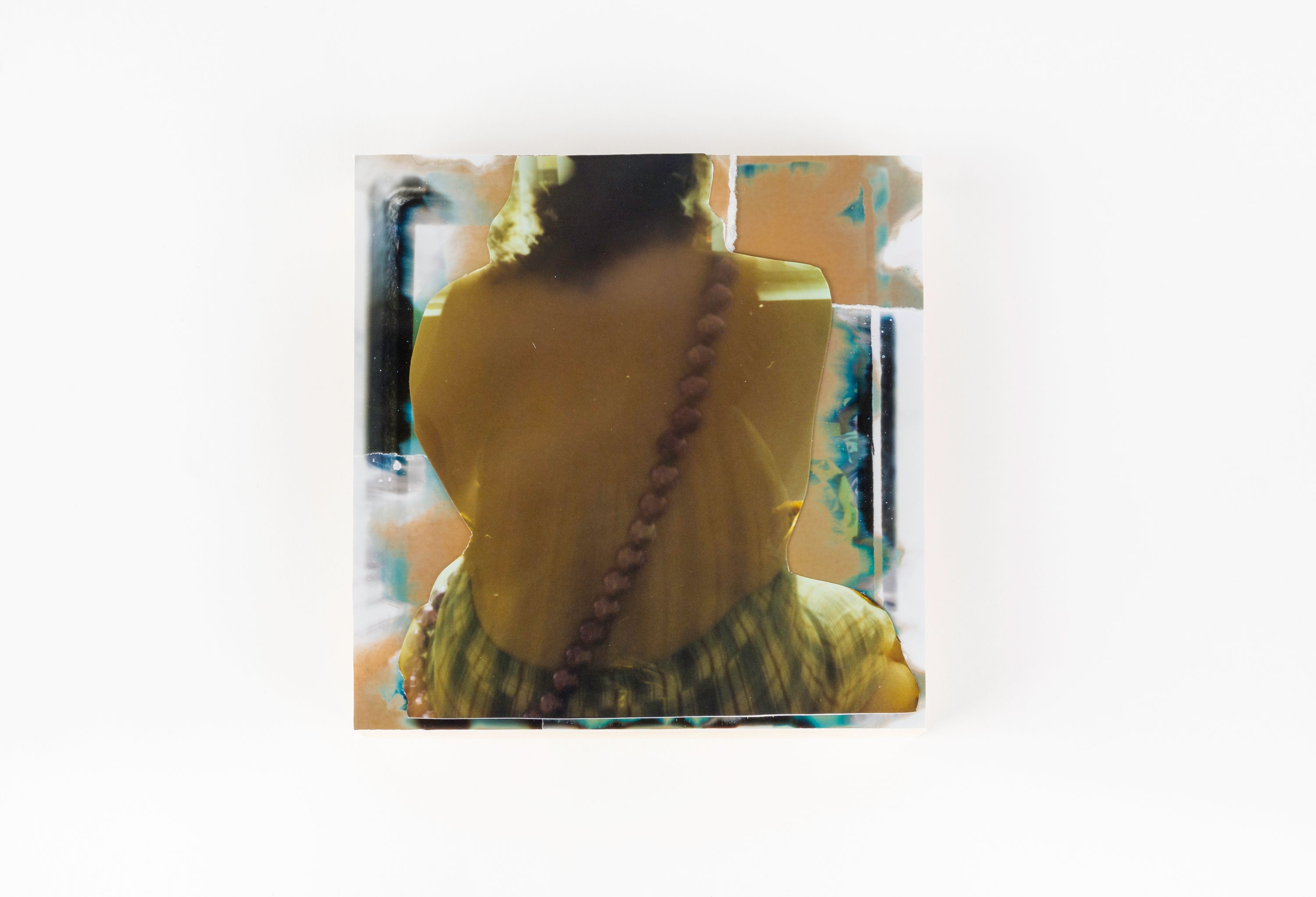 Person wearing a yellow garment with a patterned design on a white background