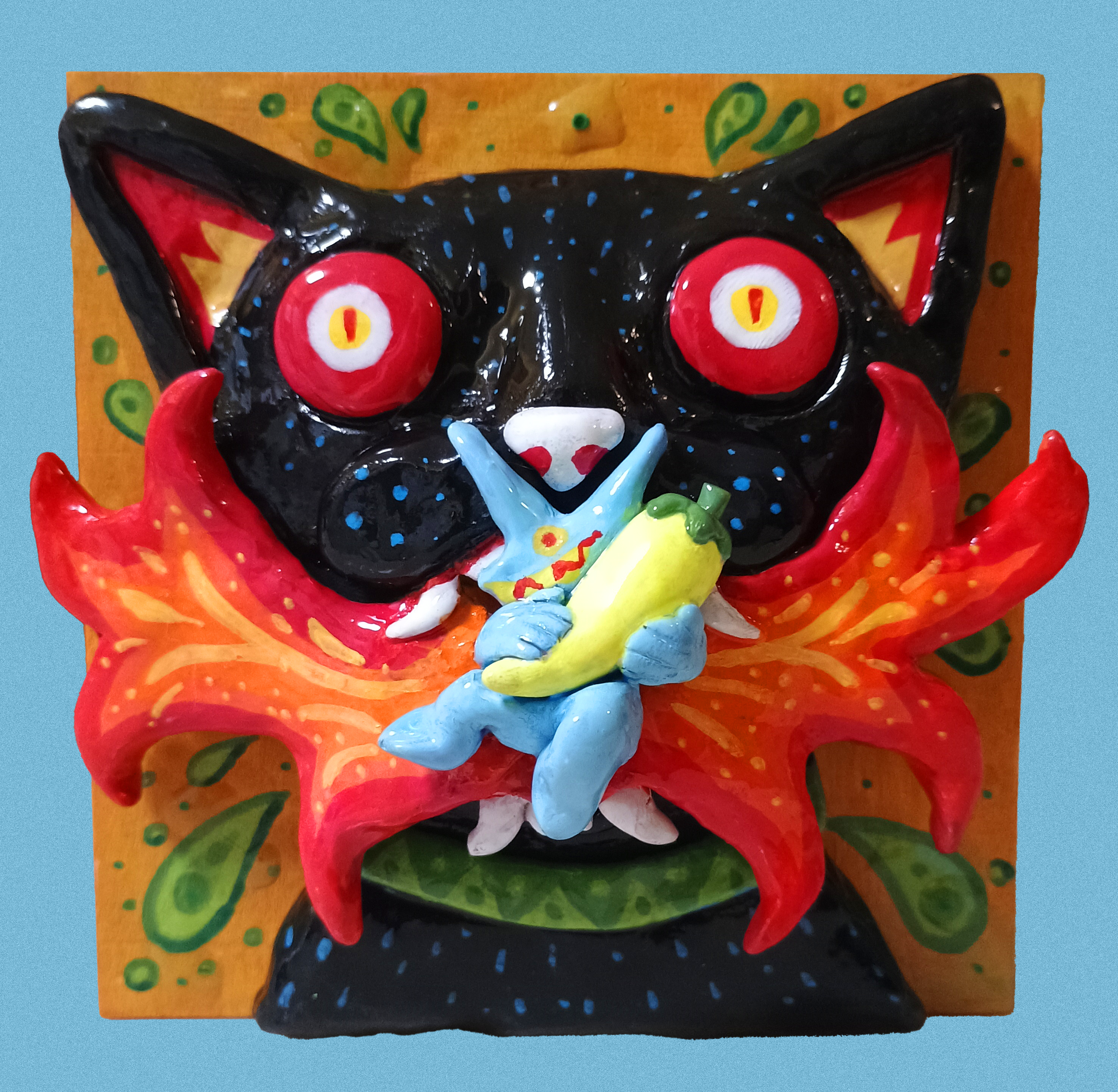 Colorful cat-like creature with red eyes and a blue character holding a banana on a decorative background.