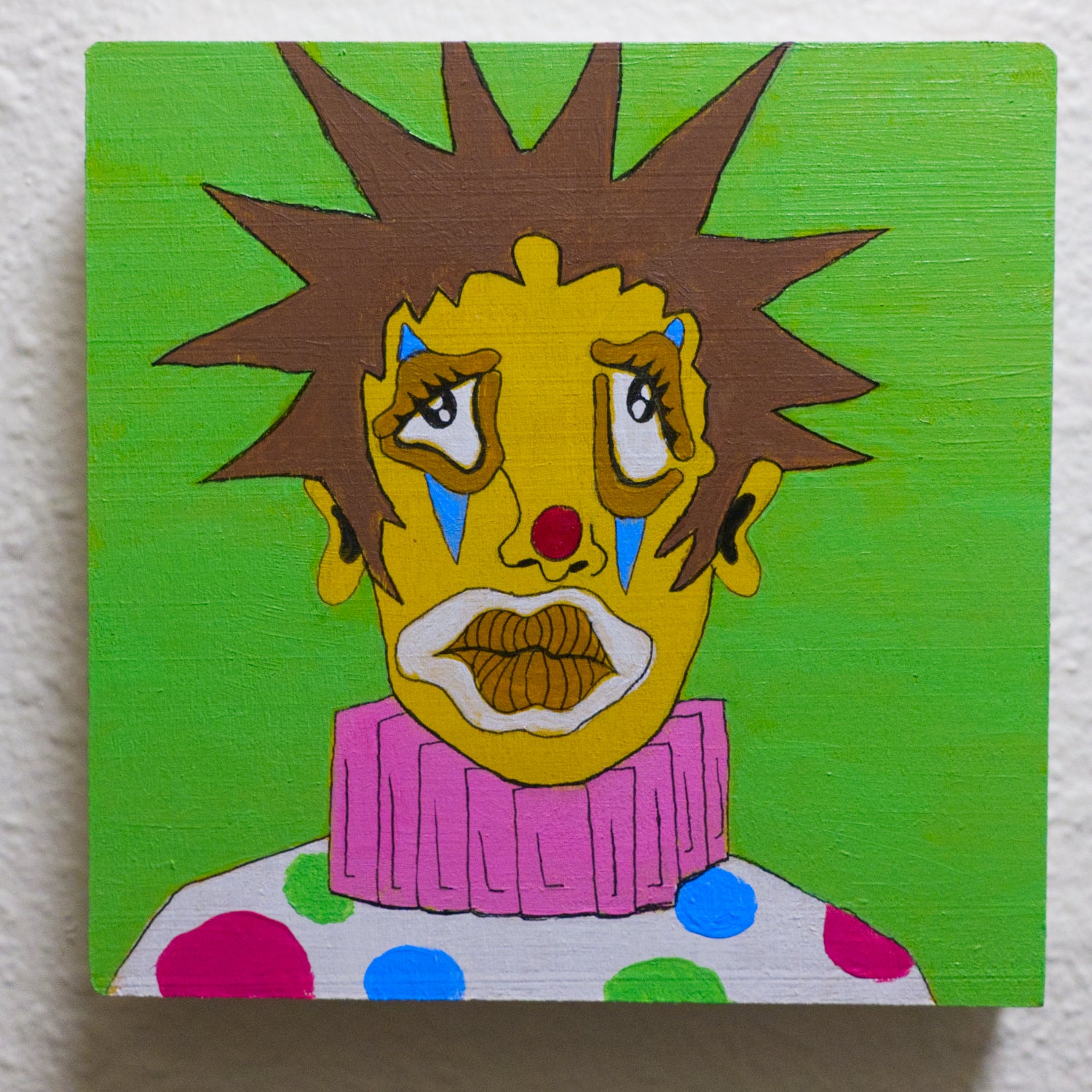 Colorful abstract painting of a face with spiky hair on a green background