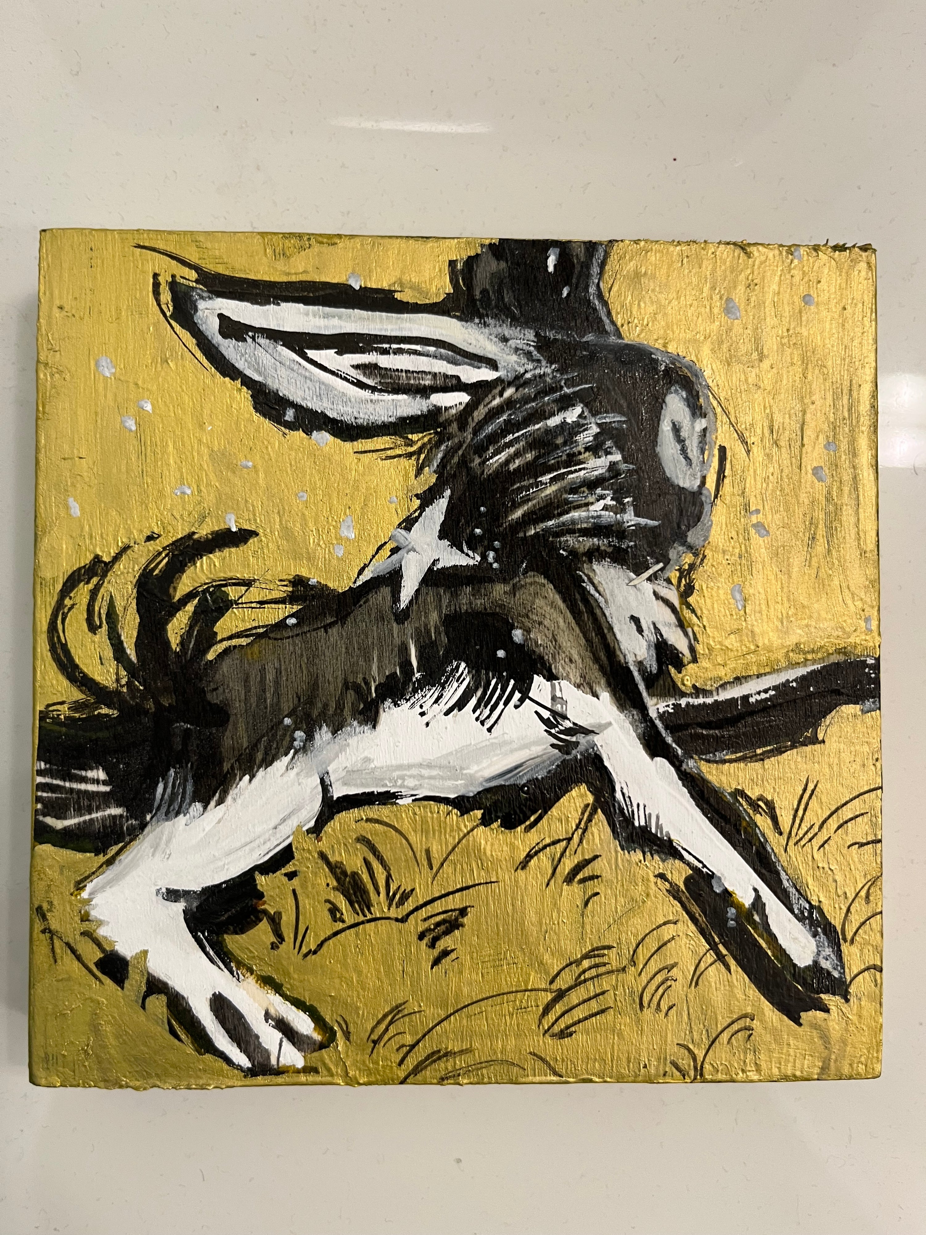 Abstract painting of a donkey on a gold background