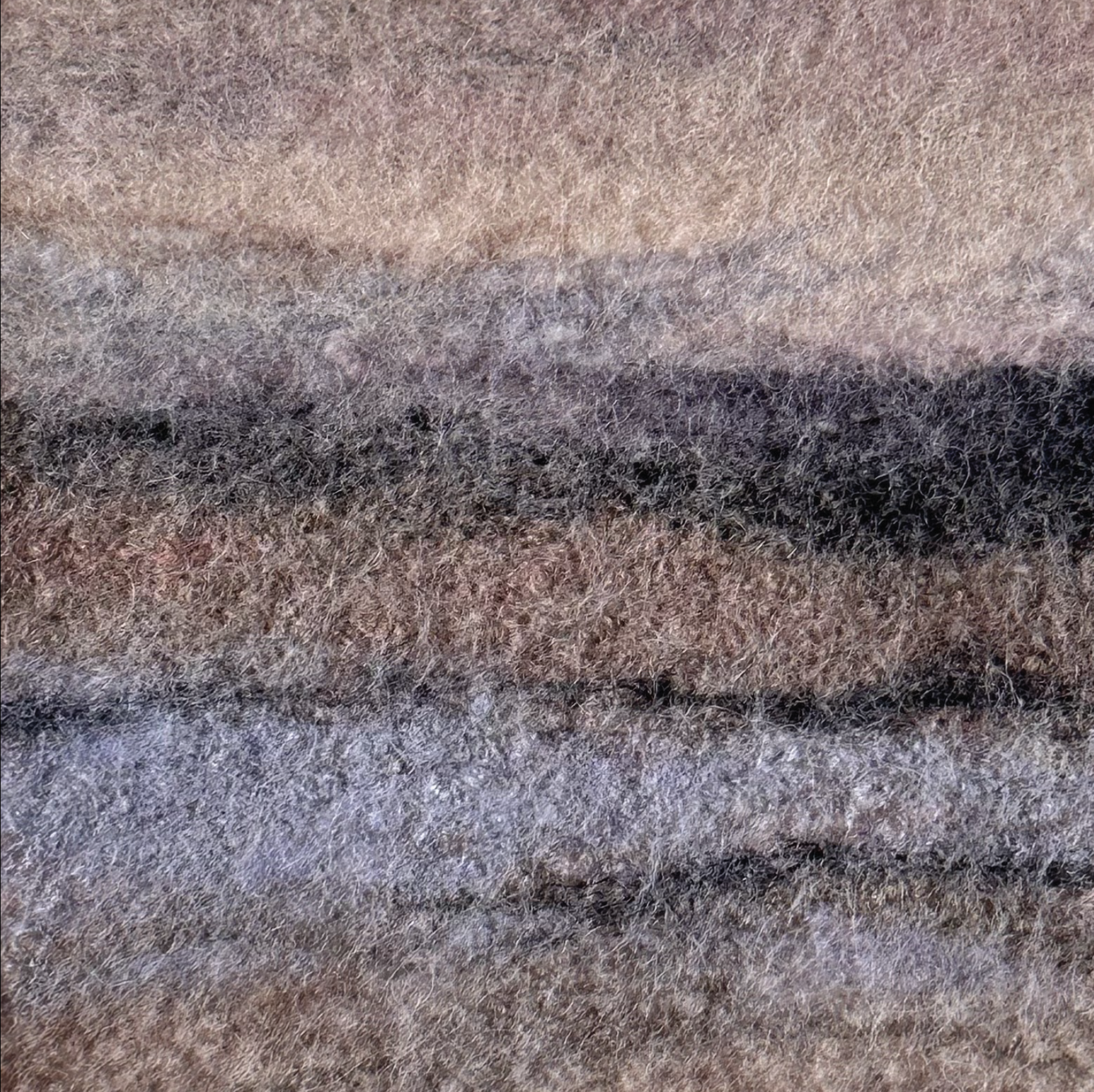 Textured fabric swatch with brown, black, and gray colors