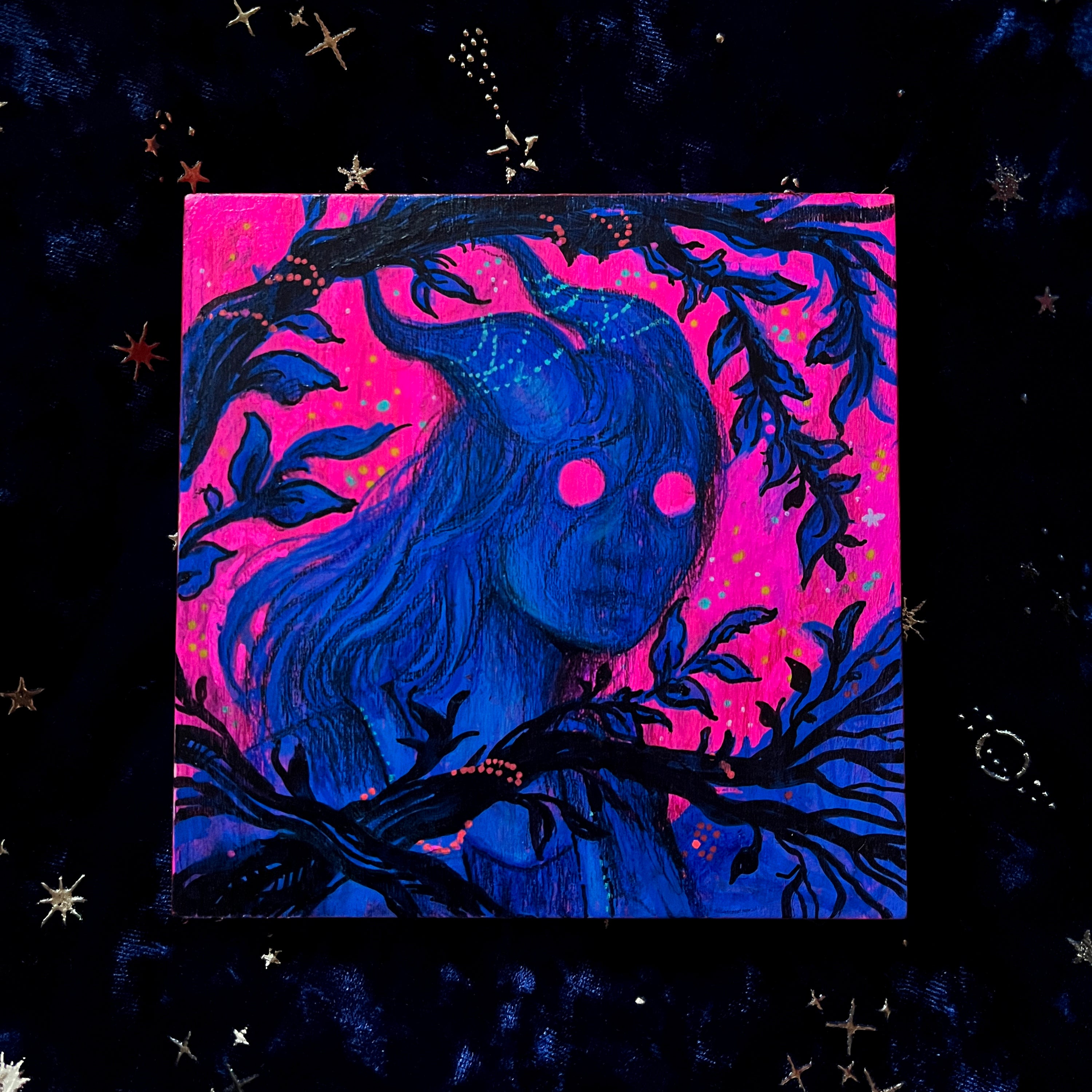 Artistic depiction of a blue-skinned figure with long hair against a pink and purple background with star decorations.