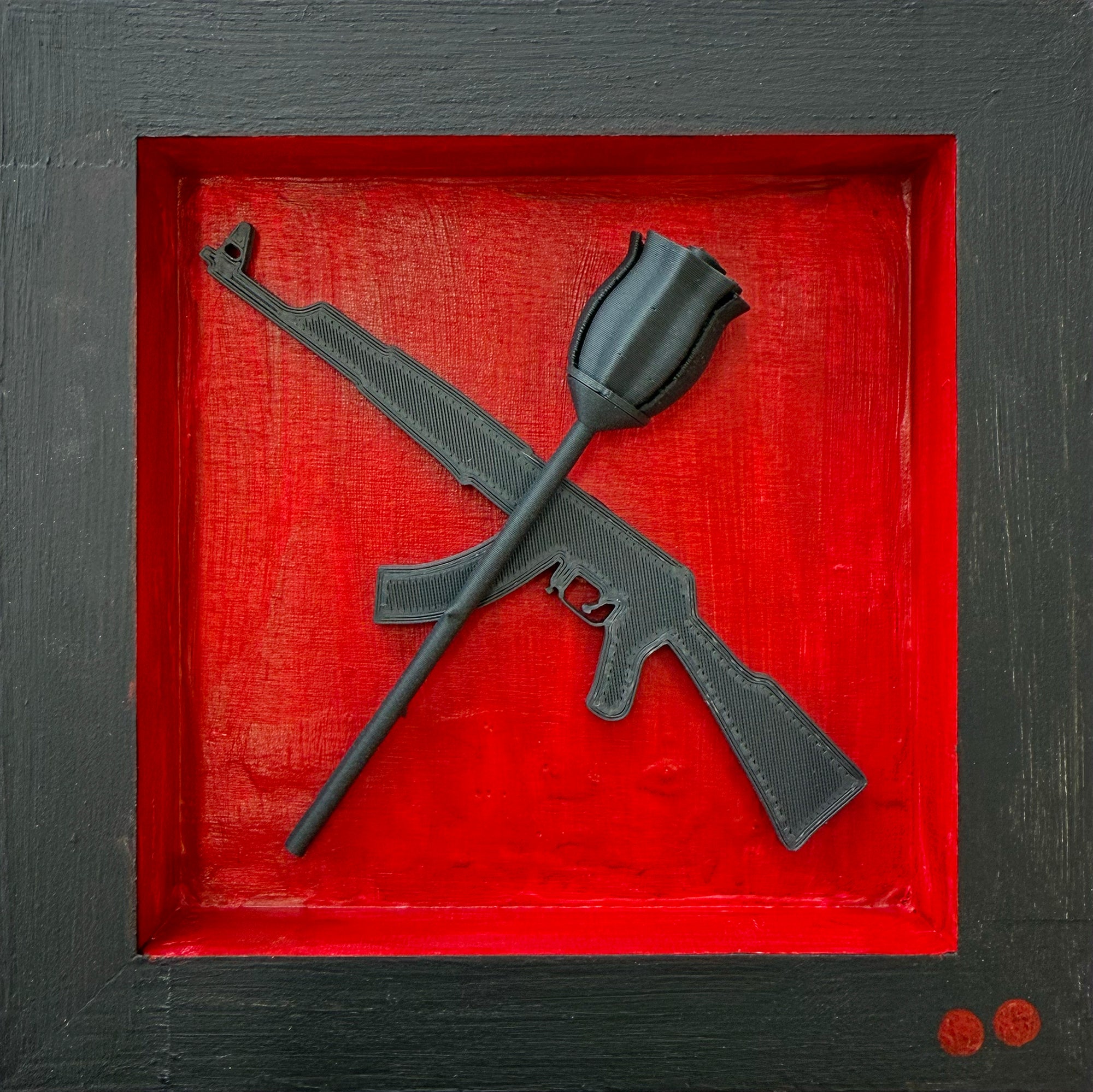 Black rifle and rose sculpture on a red background