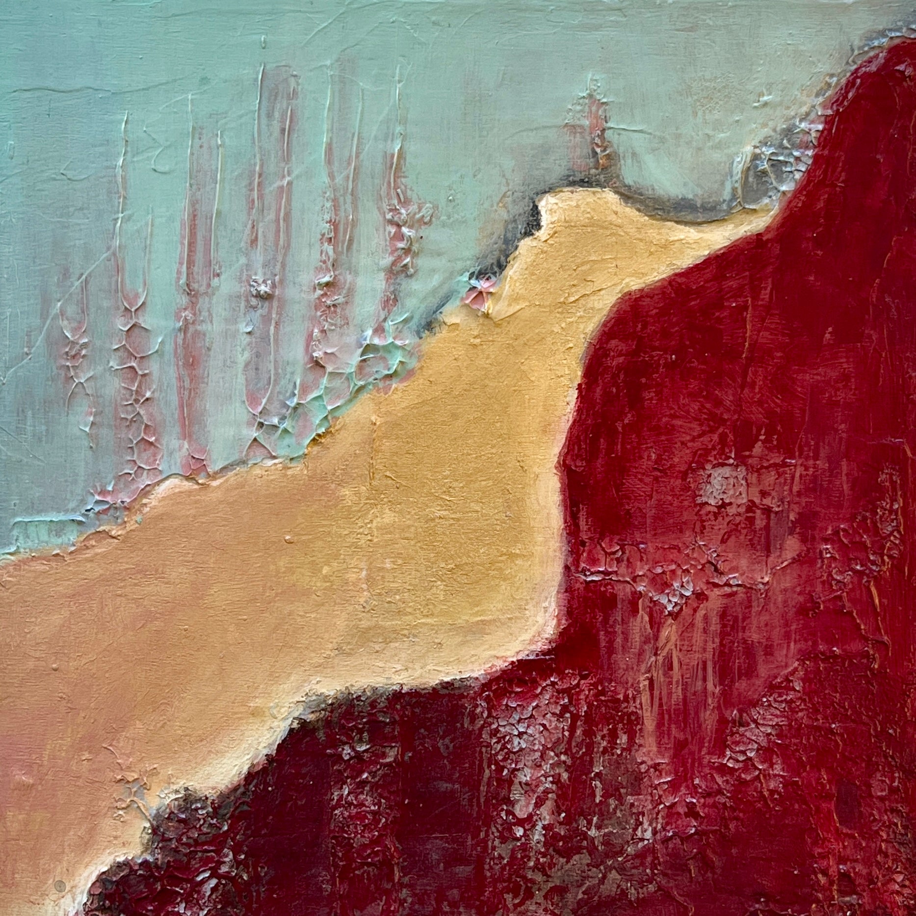 Abstract art with red, gold, and green colors on a textured surface