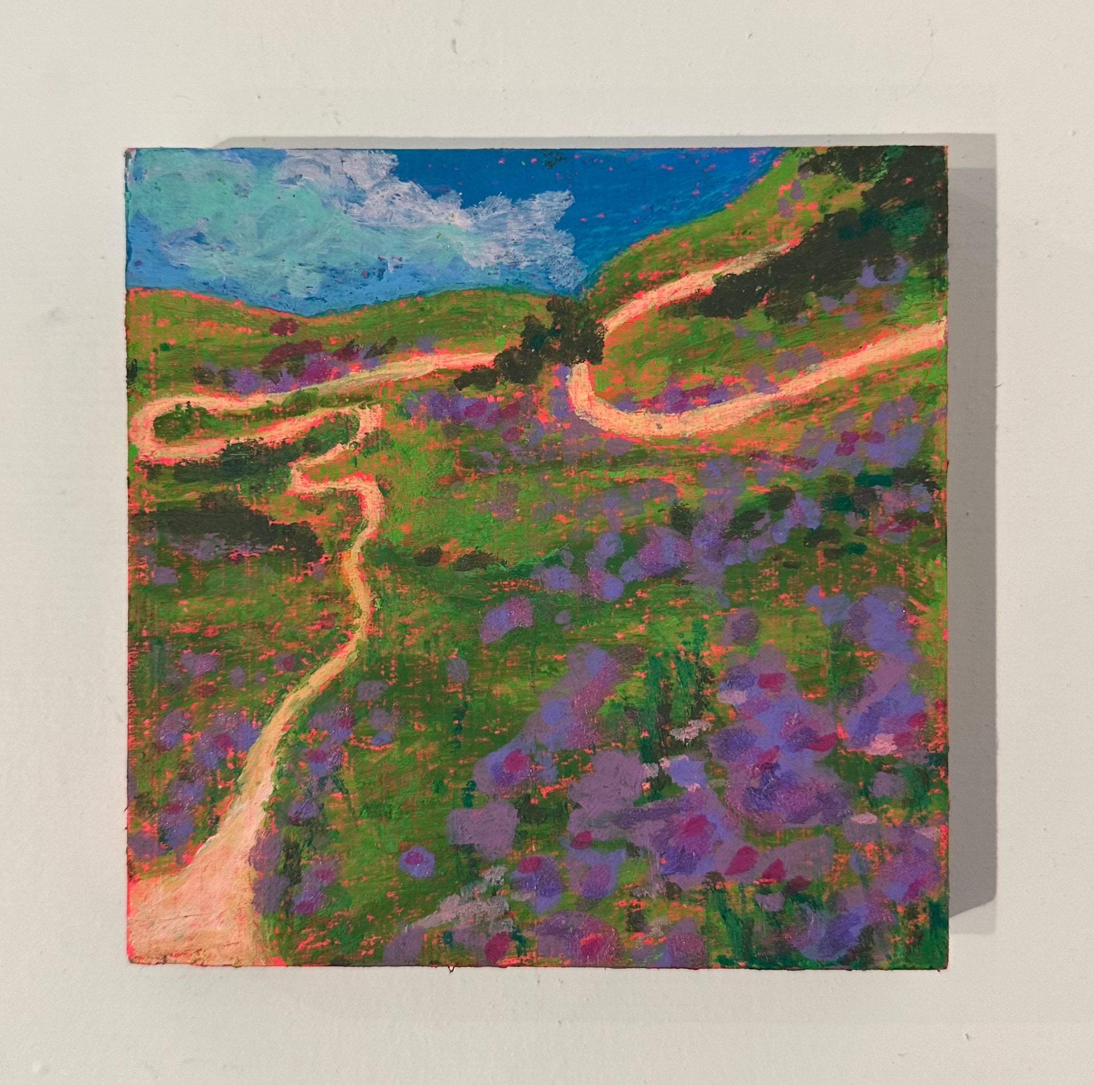 Painting of a winding road through a landscape with purple flowers and green hills.