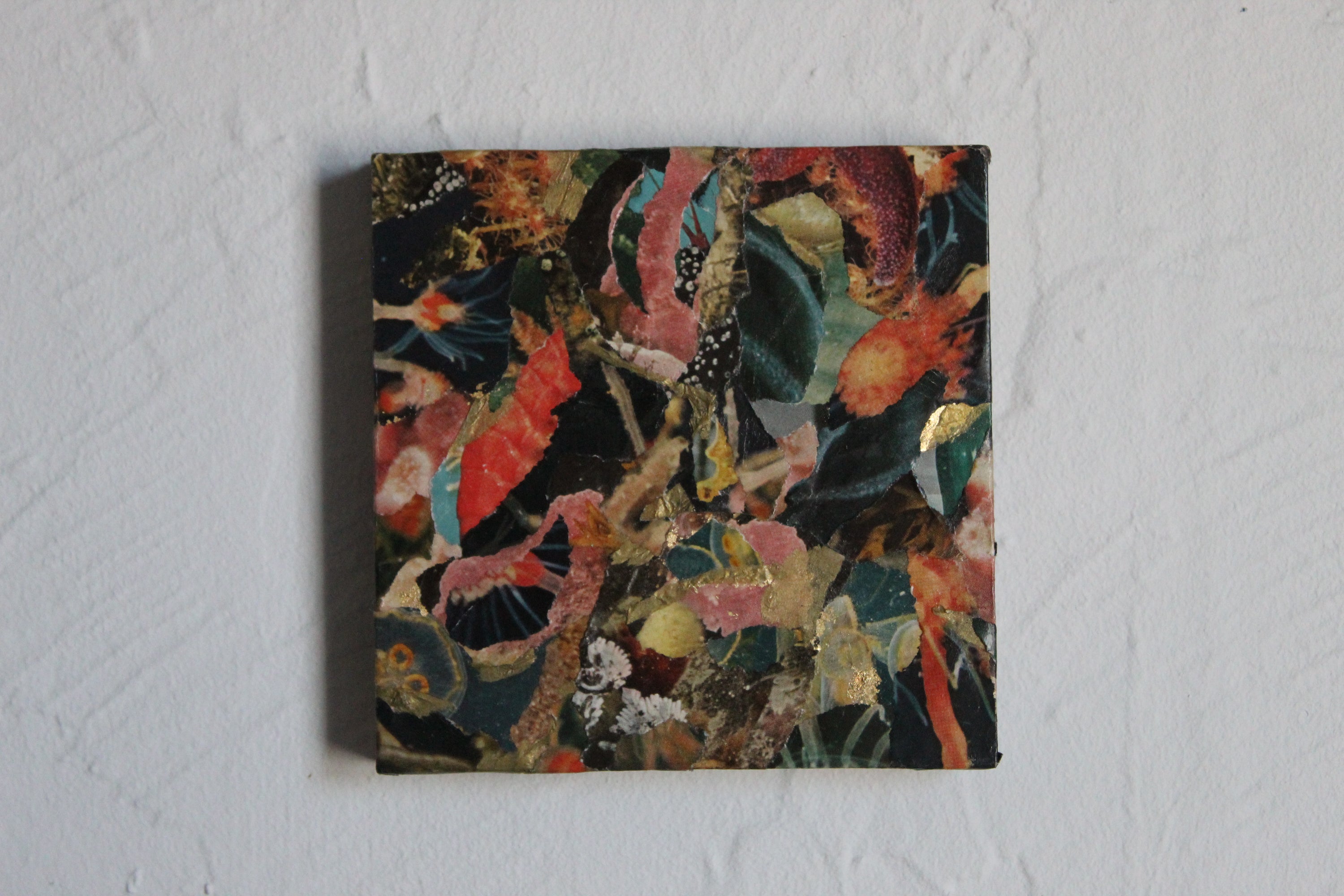 Abstract multicolored painting on a textured white wall