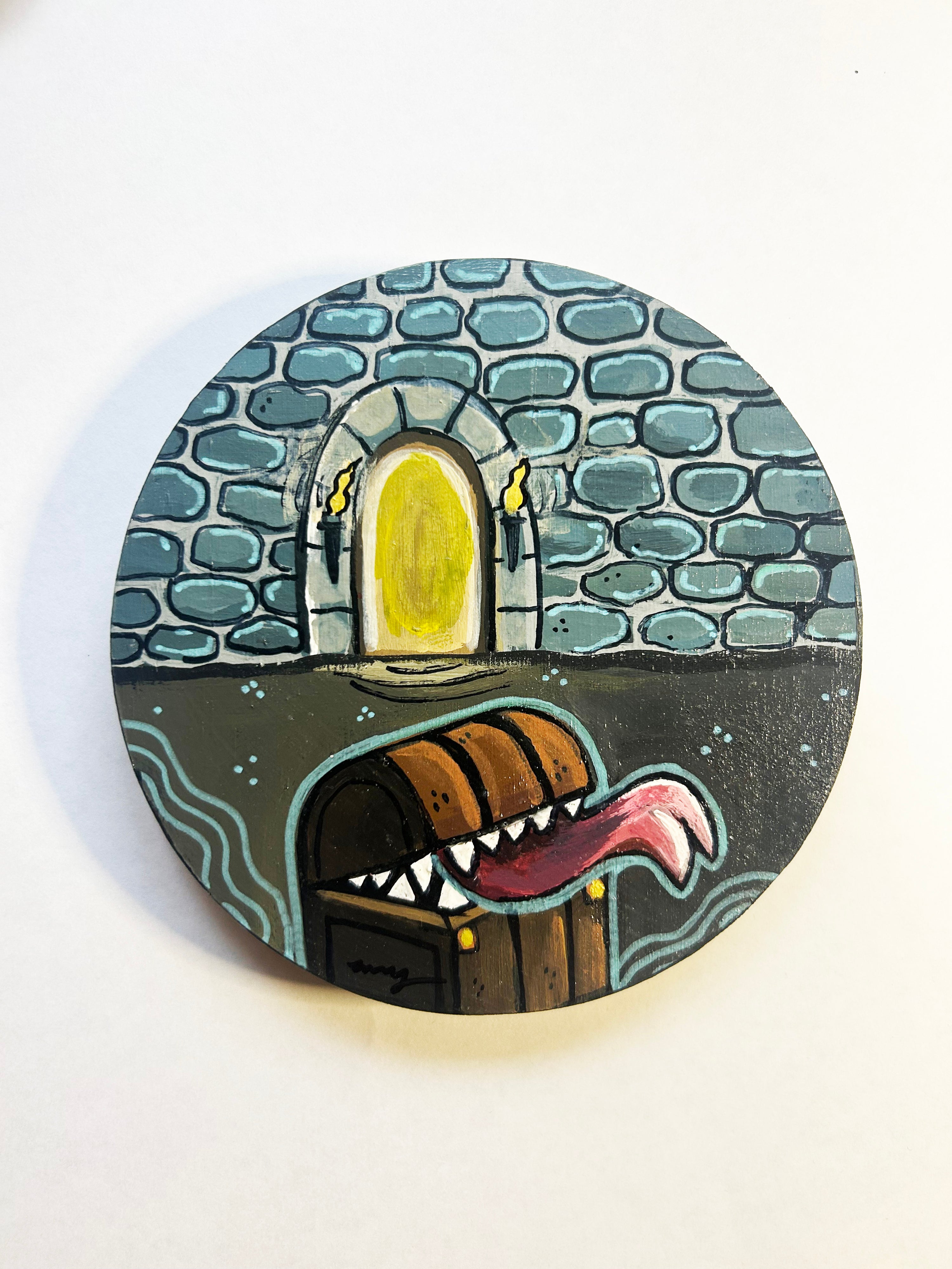 Round coaster with a dragon design and stone archway on a white background