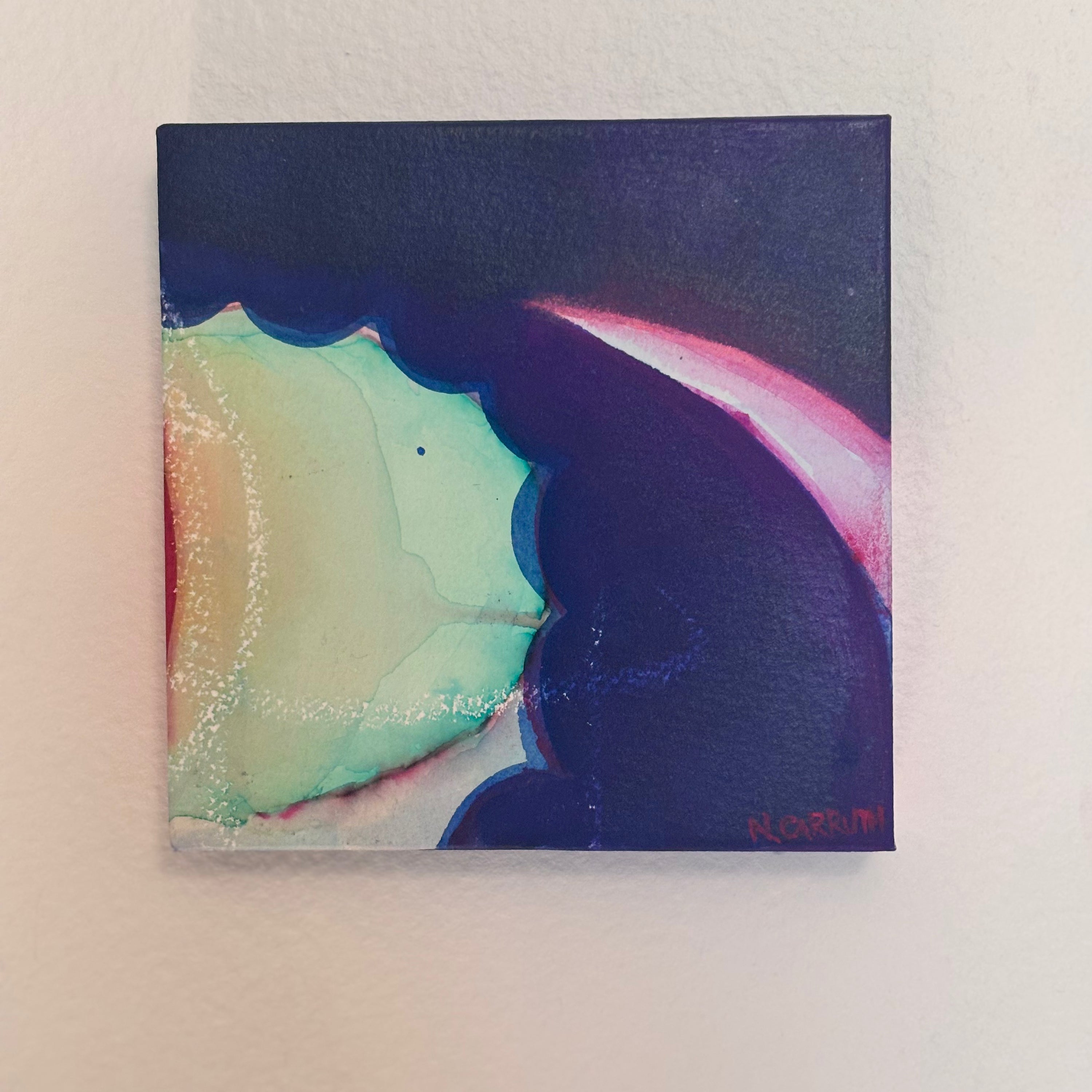 Abstract painting with colorful shapes on a white wall