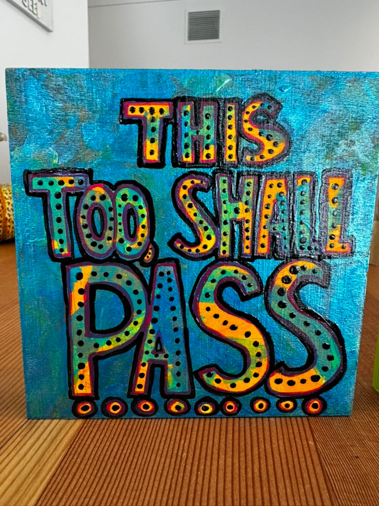 Colorful text artwork on a blue background with 'This Too Shall Pass' quote.