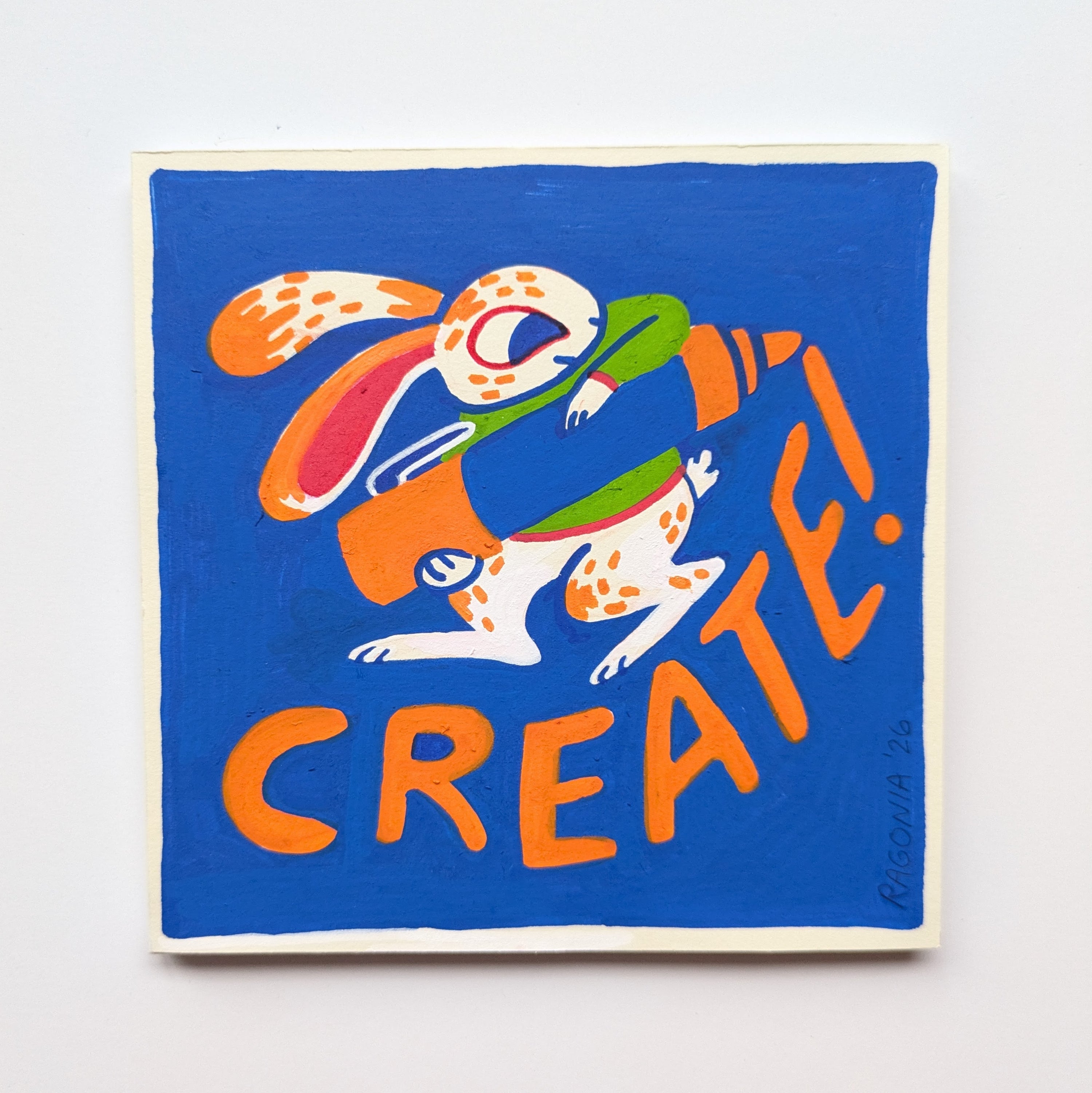 Colorful artwork with a rabbit and snake design and the word 'CREATE!' on a blue background.