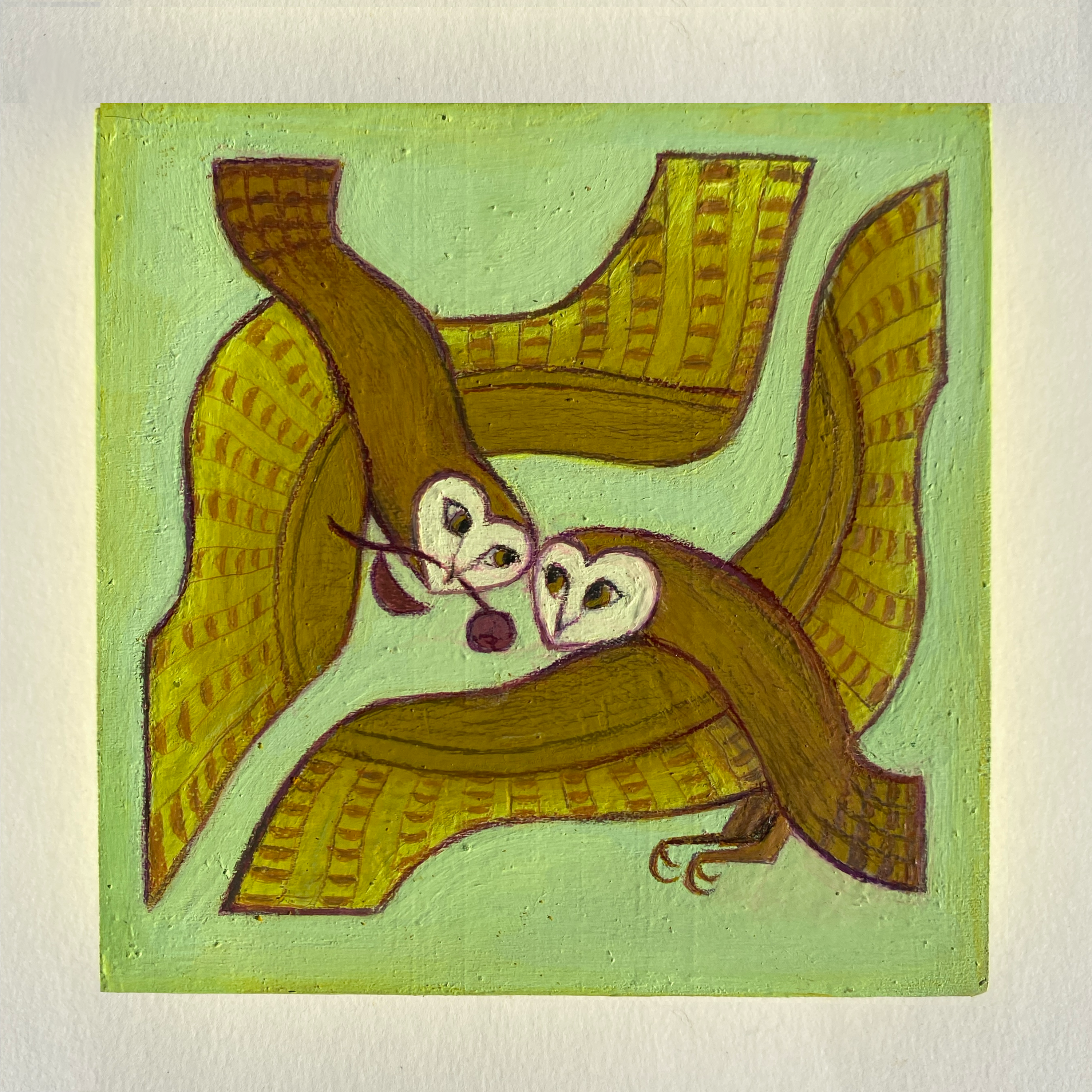 Two owls on a leaf with a green background