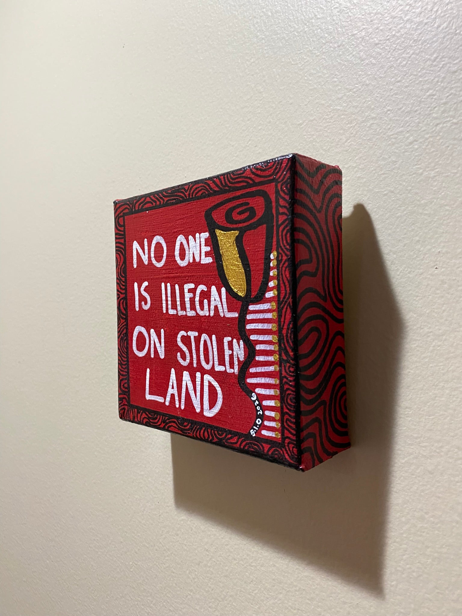 Small red box with a message on a white wall