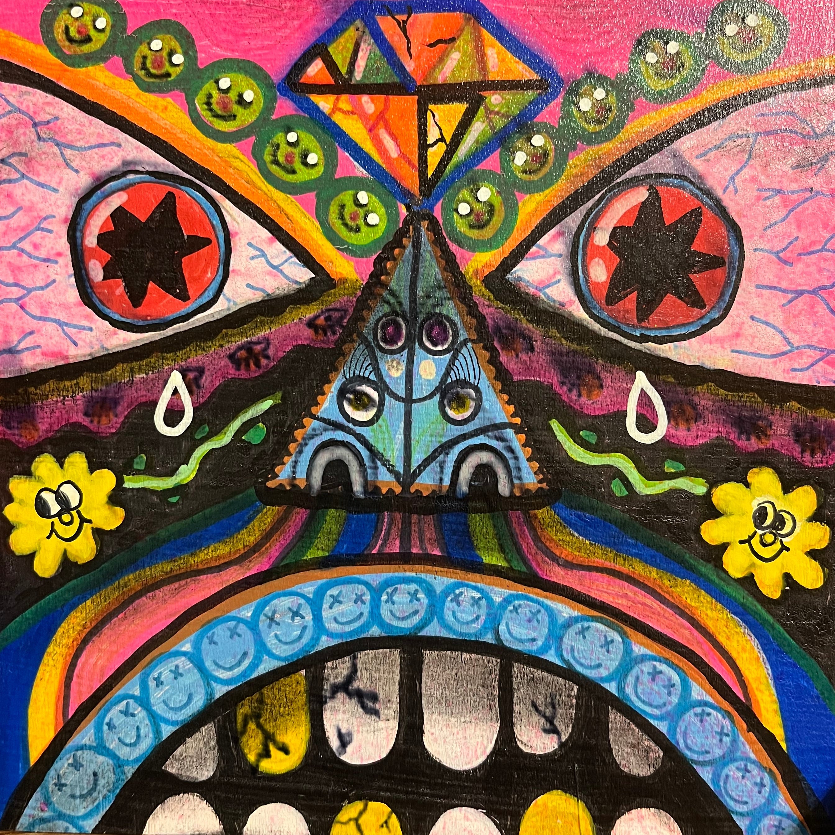 Colorful abstract painting with geometric shapes and patterns on a wooden surface.